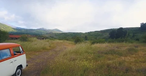Caravan riding through the vacant road on a meadow on mountains Stock Footage 81534997