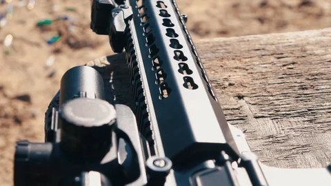 The carbine with optical sight rests on the table. Close-up. Dolly shot. Stock Footage 89811895
