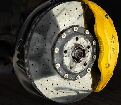 Carbon Ceramic Brake disc, yellow caliper on a Lamborghini Urus car. Stock Photos