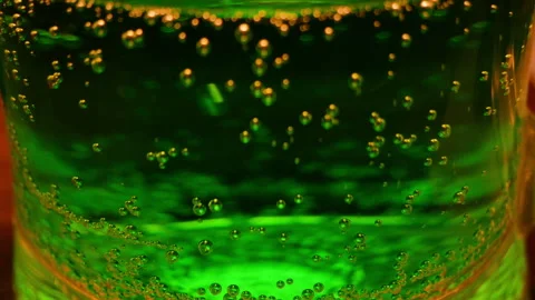Carbon dioxide. The release of carbon dioxide from beer or soda through a glass  Stock Footage 276459014