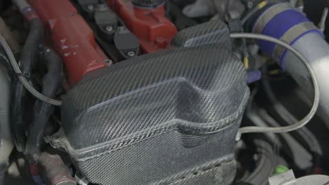 Carbon fiber engine cover and red cylinder head Stock Footage 340773828