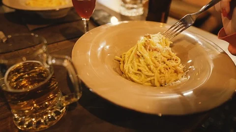 Carbonara paste. A man eats an Italian dish of pasta carbonara Stock Footage 122644355