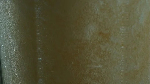 Carbonated bubbles rising through refreshing amber liquid Stock Footage 327179264