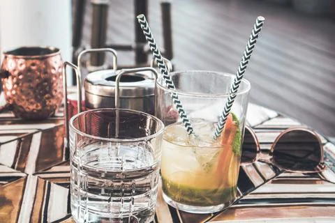 Carbonated soft drinks on a mosaic table in a cafe, bar. Gin tonic cocktail Stock Photos