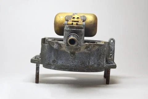 Carburetor float assembly, attached to air intake horns body. Carburetor co.. Stock Photos