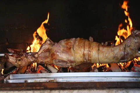 The carcass of the goat is fried on a spit Stock Photos