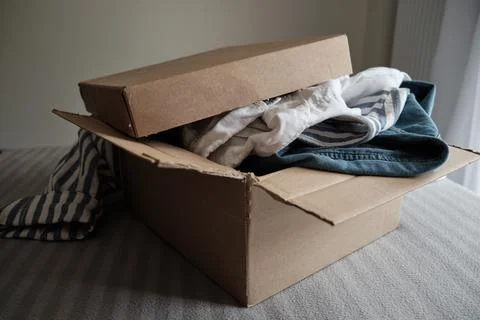 Card box with clothes inside. Donation Concept or Second hand Stock Photos