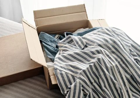 Card box with clothes inside Stock Photos