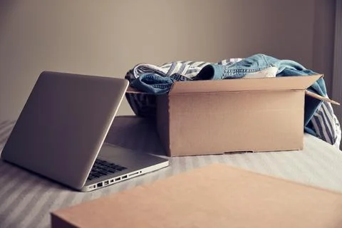 Card box with clothes inside Stock Photos