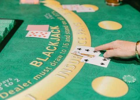 Card game in action at a blackjack table in a vibrant casino Stock Photos