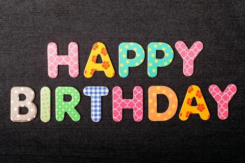 Card with Happy Birthday words made from mixed vivid colored wooden letters Stock Photos