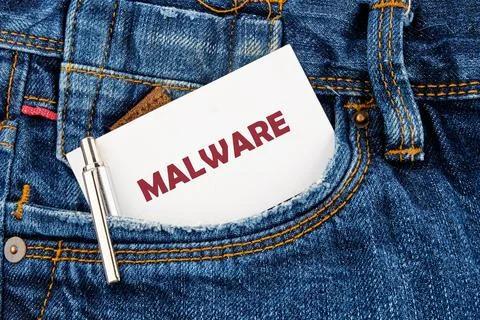 A card labeled with the word malware is placed in the pocket of a pair of blu Stock Photos