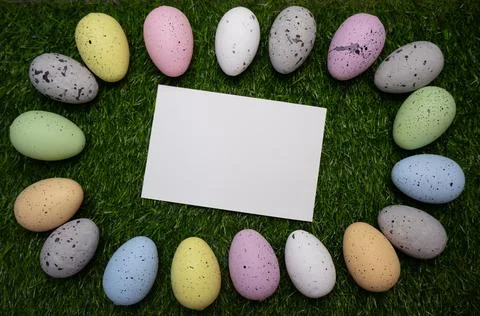Card for message with Easter frame of colorful eggs on grass Stock Photos