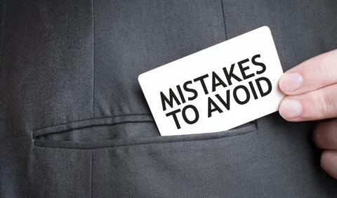 Card with MISTAKES TO AVOID text in pocket of businessman suit. Investment .. 写真素材