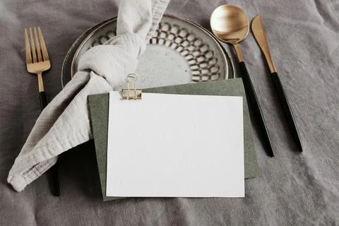 Card mockup on table place setting neutral gray color linen tablecloth backgroun Stock Photos
