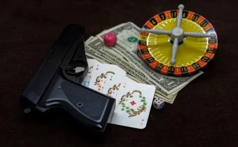 Card with money. gun and roulette Stock Photos
