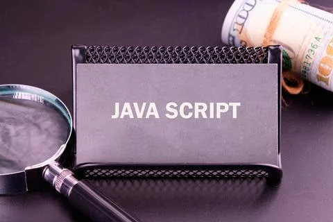 A card prominently featuring the words JavaScript is placed on a sleek black  Stock-Fotos