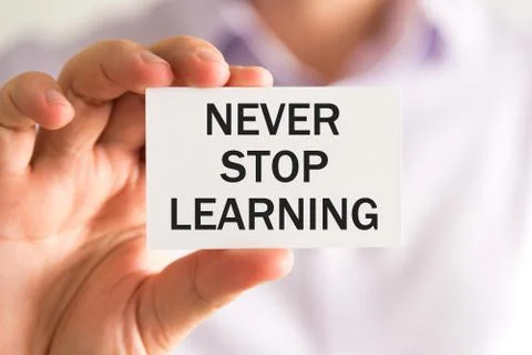 Card with text NEVER STOP LEARNING Stock Photos