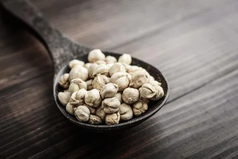 Cardamom in wooden spoon Stock Photos