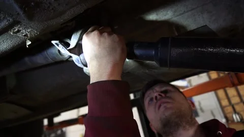 Cardan shaft a mechanic disassembles an old Video stock 221433625