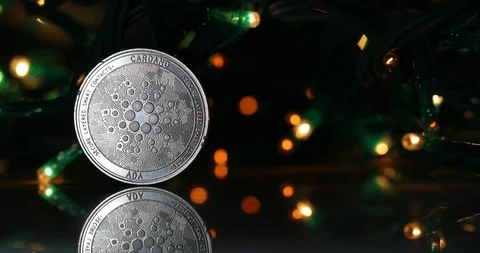 Cardano ADA coin next to blinking lights Video stock 100194352