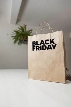 Cardboard bag written Black Friday on the table brown paper packaging with cu 스톡 사진