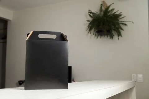 Cardboard box with 10% off order written on the box placed on the floor in an Фото