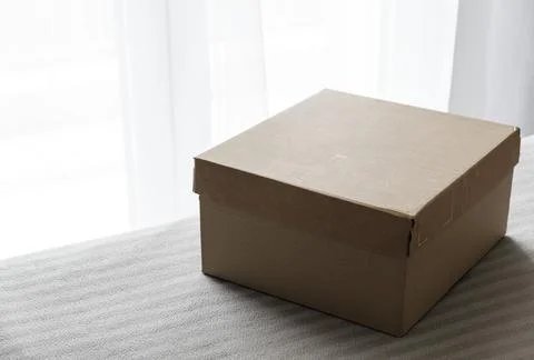Cardboard box on the bed Stock Photos