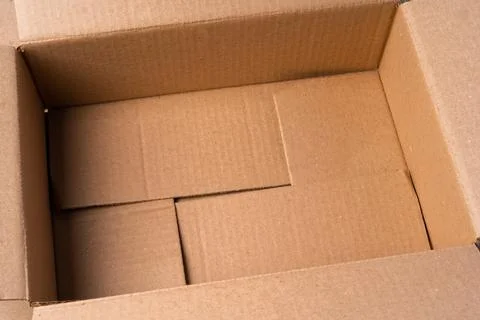 Cardboard box on beige background in studio Foto stock