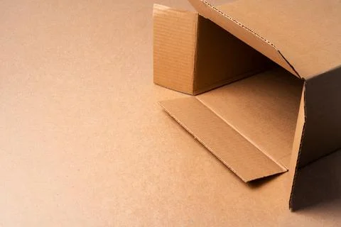 Cardboard box on beige background in studio Stock Photos