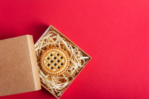 Cardboard box with cookie on red background.. Stock Photos