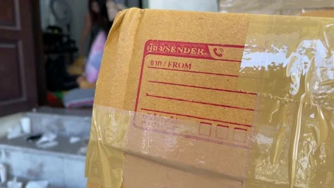 Cardboard box package sender and postcode Thai word screen on parcel Stock Footage 225125480