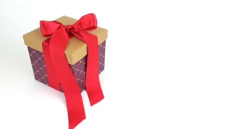 Cardboard box with a red bow. Stock Photos