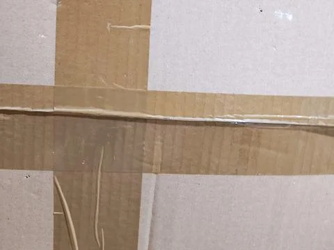 Cardboard box surface with clear packing tape sealing Stock-Fotos