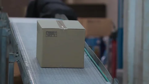 Cardboard boxe progresses along conveyor belt. Cardboard boxes on conveyor belt Stock Footage 122058673