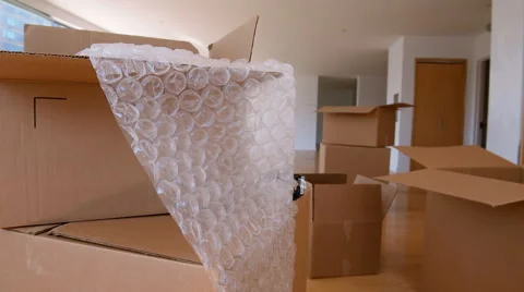 Cardboard boxes and bubble wrap in empty apartment Stock Footage 67193952