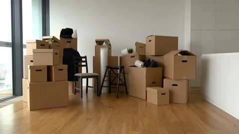 Cardboard boxes and chairs in the interior of an apartment Stock-Footage 114771952