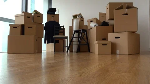 Cardboard boxes and chairs in the interior of an apartment - view from the 動画素材 114772165