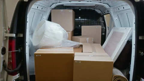 Cardboard Boxes and Packages Loaded in Delivery Van Inside Storage Unit Stock Footage 340282329
