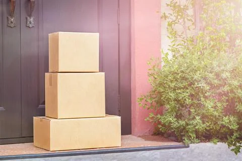 Cardboard boxes are in front of the door Stock Photos