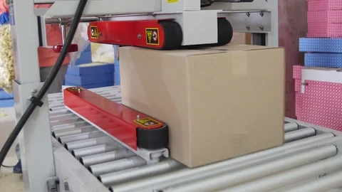 Cardboard boxes are weighed on a transporter of a packaging line Stock Footage 76292488