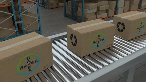 Cardboard boxes with Bayer Logo on conveyor belt on warehouse background. Stock Footage 230039587