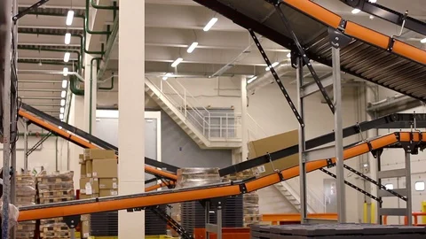 Cardboard boxes on conveyor belt inside warehouse Stock Footage 91004855