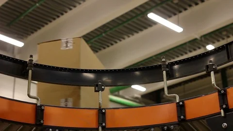 Cardboard boxes on conveyor belt inside warehouse Stock Footage 91004973
