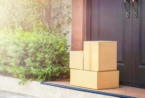 Cardboard boxes on the doorstep  delivery Stock Photos