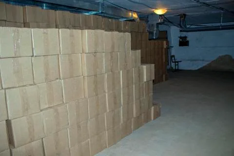 Cardboard boxes with goods in the basement. Stock Photos