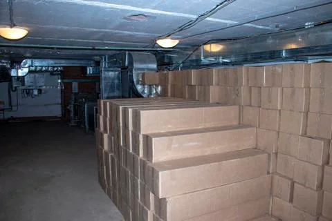 Cardboard boxes with goods in the basement. Stock Photos