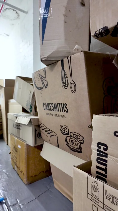 Cardboard boxes piling up along a neglected and messy office building hallway 動画素材 331028128