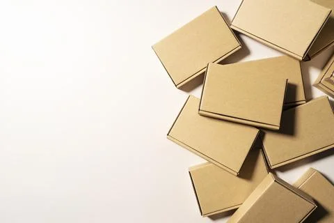 Cardboard boxes placed on a beige background. Stock Photos