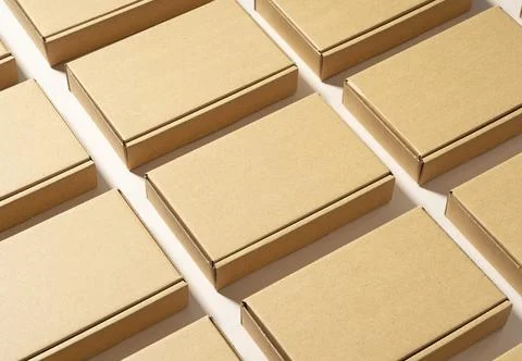 Cardboard boxes placed on a beige background. Stock Photos
